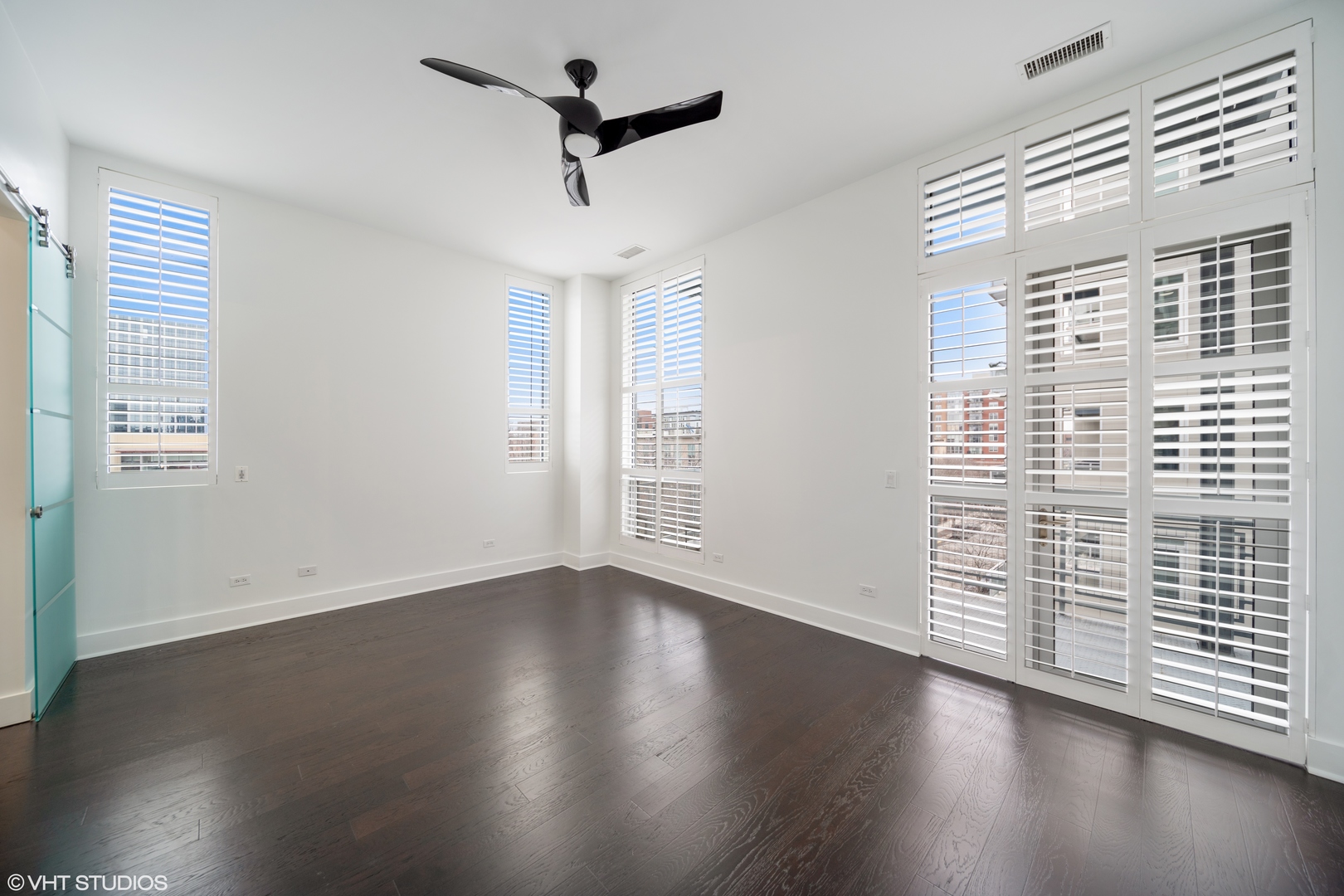1100 West Adams Street, Unit 4S Chicago, IL 60607 - Photo 17 of 21 wooden floor in an empty room with a window