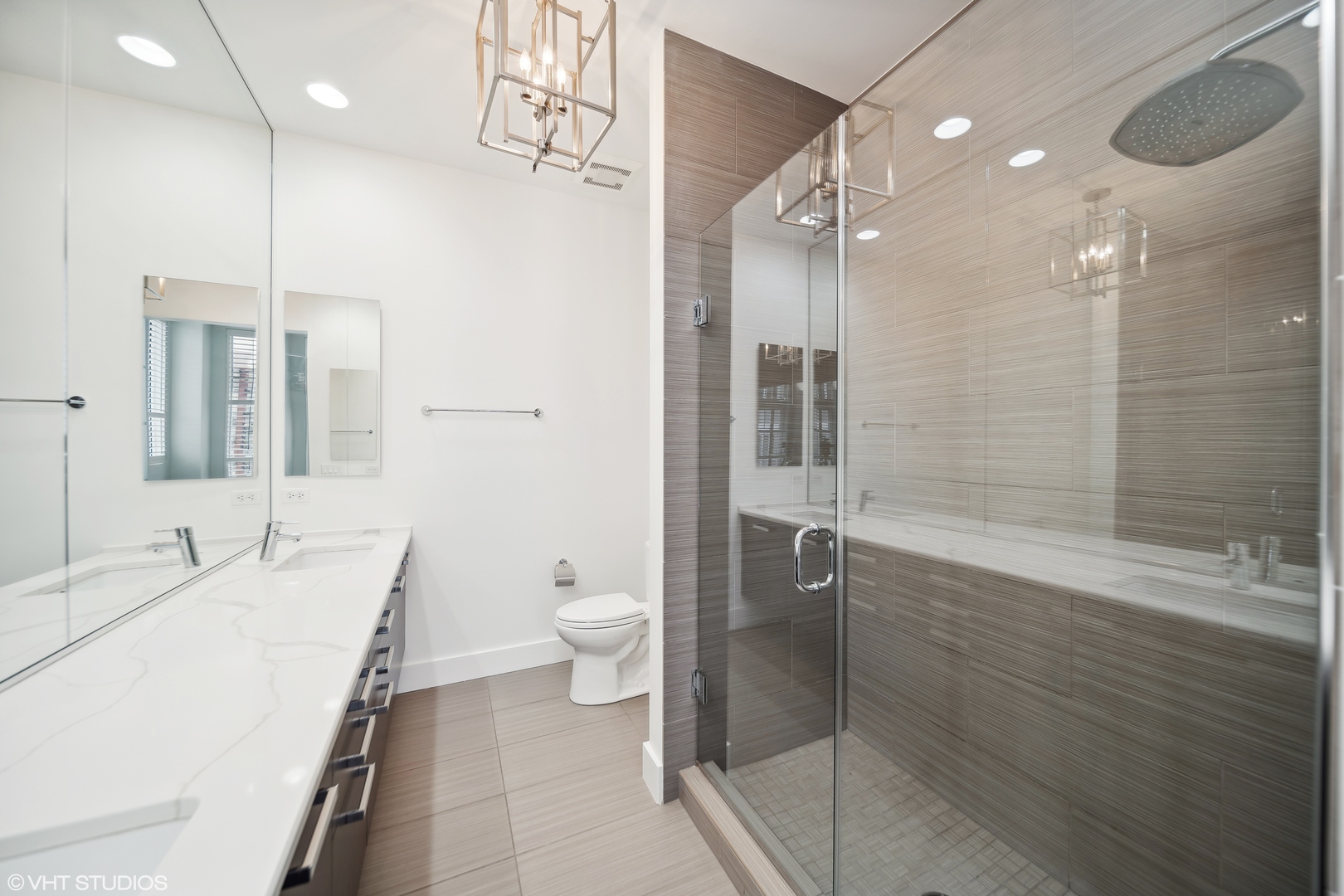 1100 West Adams Street, Unit 4S Chicago, IL 60607 - Photo 19 of 21 a spacious bathroom with a shower sink vanity mirror and toilet