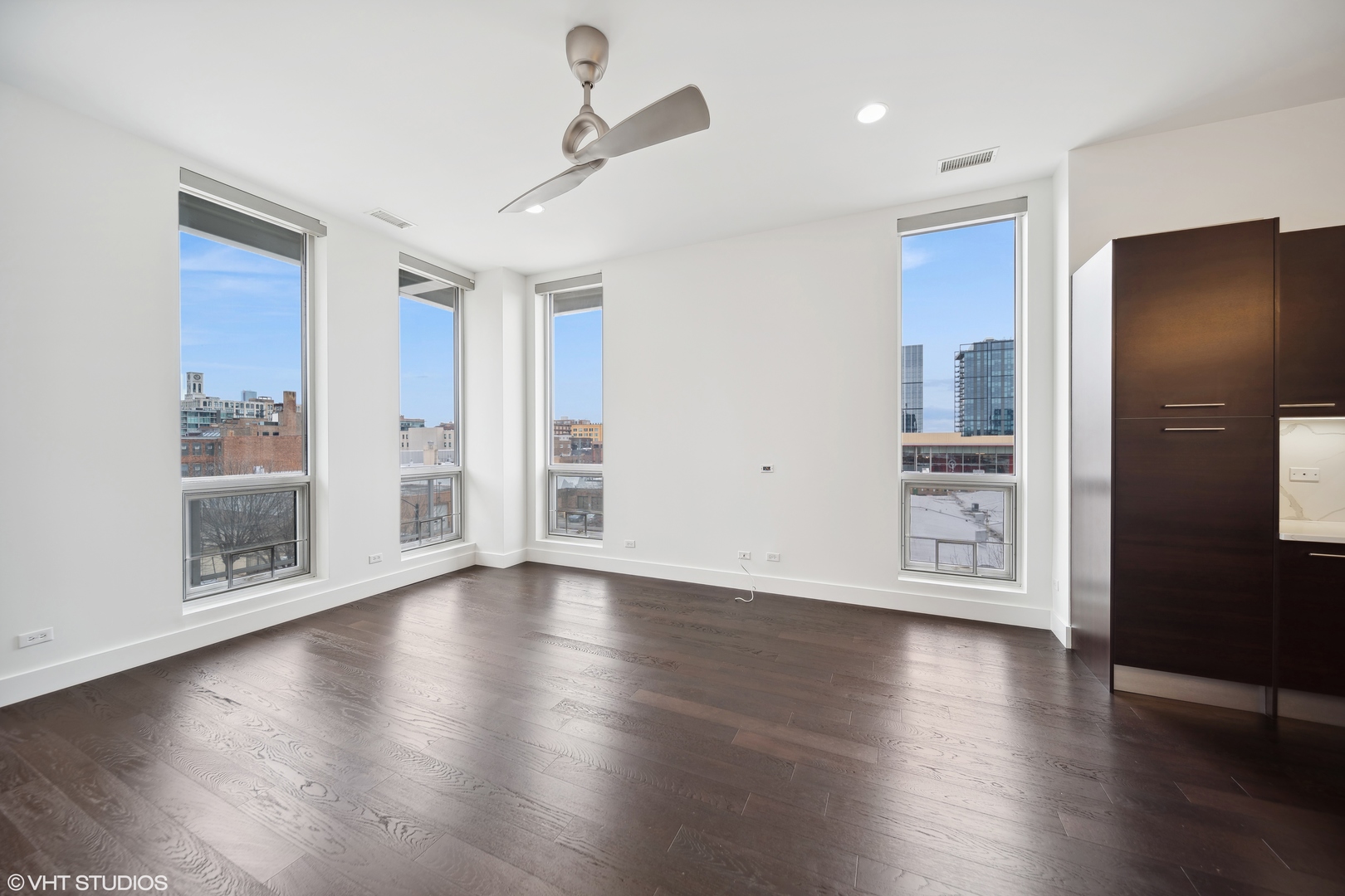1100 West Adams Street, Unit 4S Chicago, IL 60607 - Photo 3 of 21 a view of an empty room with wooden floor and a window
