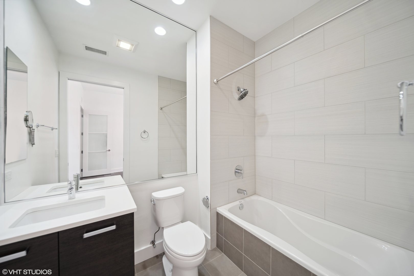1100 West Adams Street, Unit 4S Chicago, IL 60607 - Photo 8 of 21 a bathroom with a granite countertop sink a toilet and shower