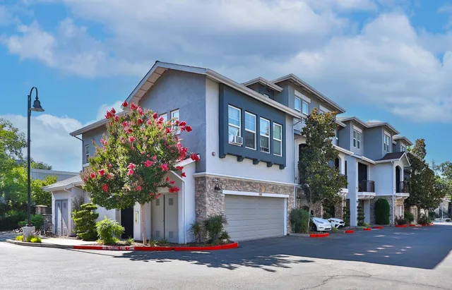 a view of a wooden house with large windows
