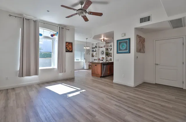 a view of a livingroom with hardwood floor and a ceiling fan