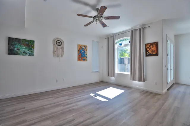wooden floor in an empty room with a window