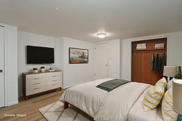 a bedroom with a bed and a flat screen tv