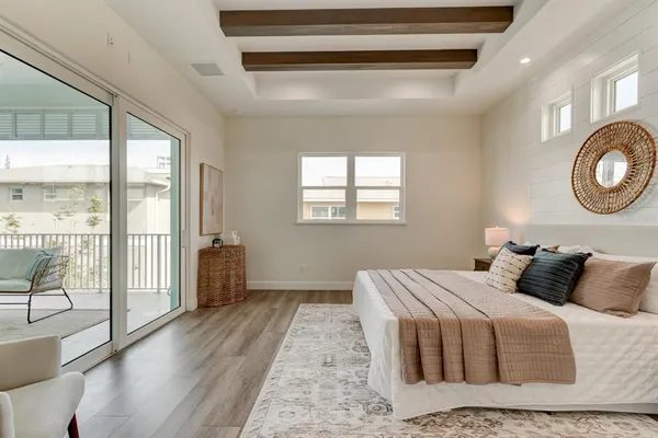 a bedroom with a bed and glass door