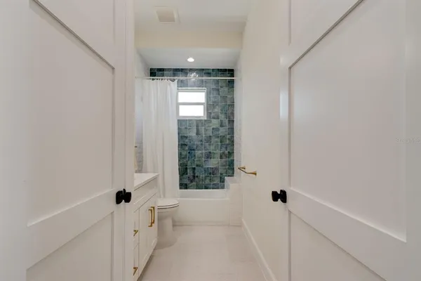 a bathroom with a bathtub and shower