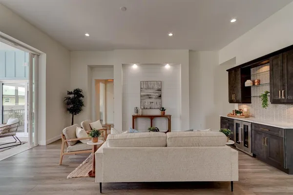 a living room with furniture and wooden floor