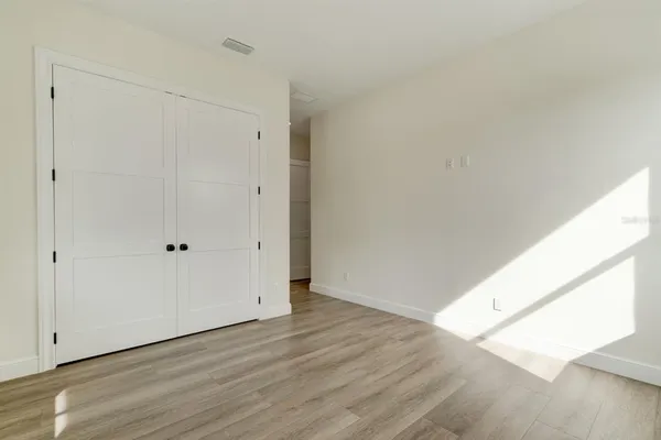 a view of an empty room and wooden floor