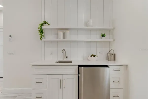 a kitchen with white cabinets and a sink