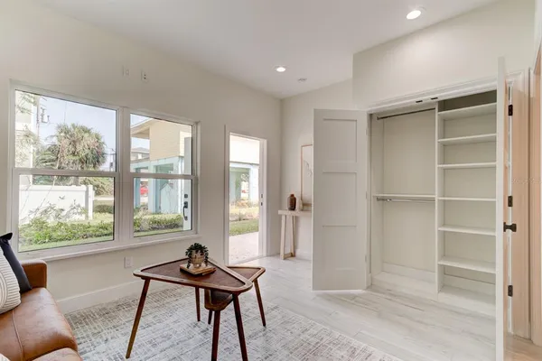 a living room with furniture a window and a potted plant