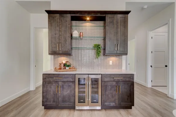 a kitchen with granite countertop wooden cabinets and floor
