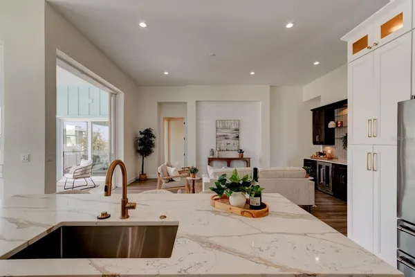 a kitchen with sink refrigerator and window
