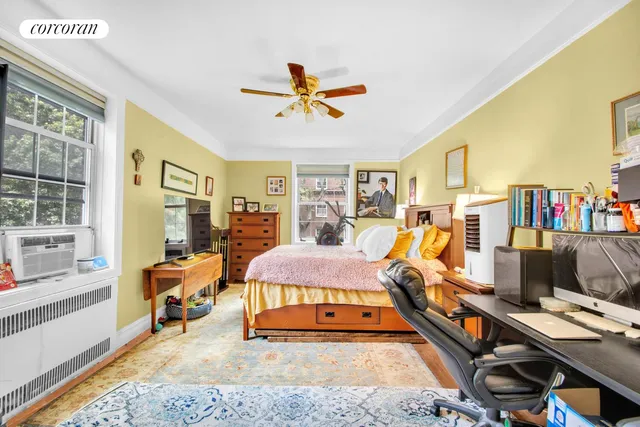 a bedroom with furniture and a flat screen tv