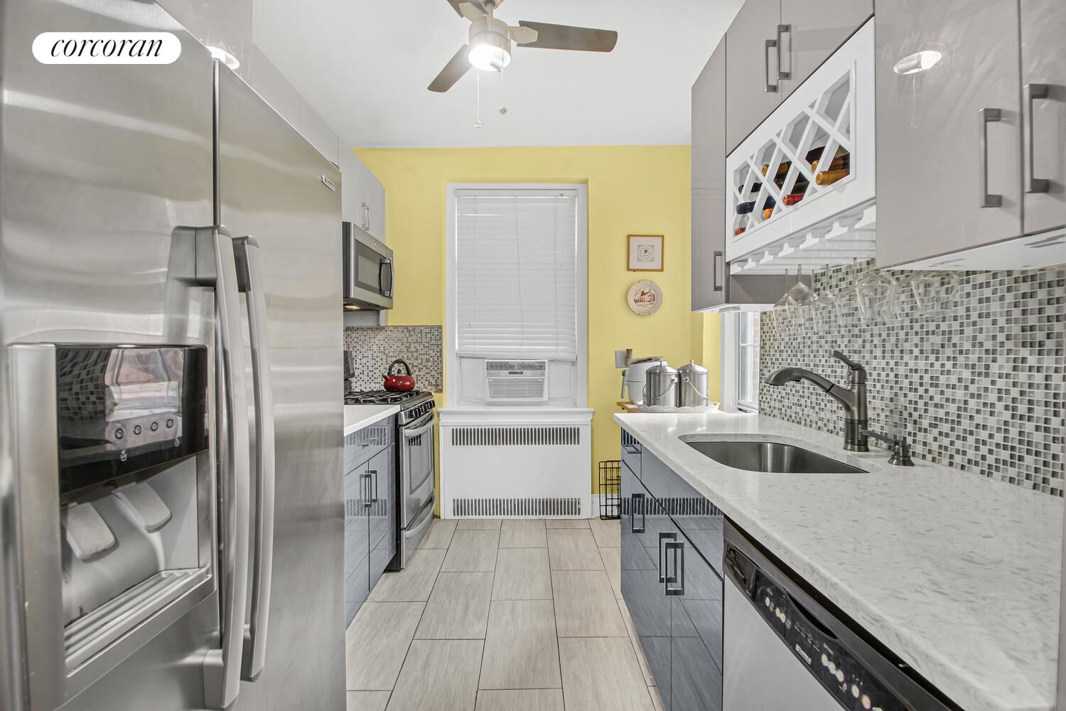 117-01 Park Lane South, Unit A6D Queens, NY 11418 - Photo 6 of 8 a kitchen with a sink and refrigerator