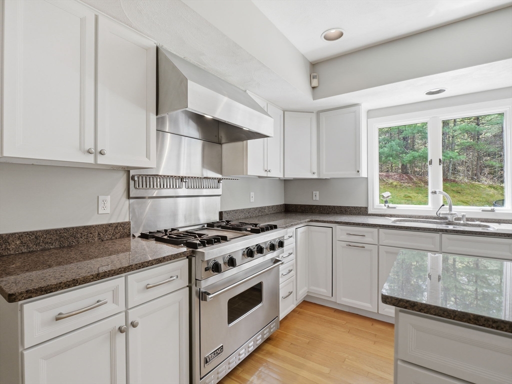 10 Hawk Ridge Road Andover, MA 01810 - Photo 5 of 32 a kitchen with granite countertop white cabinets and a stove