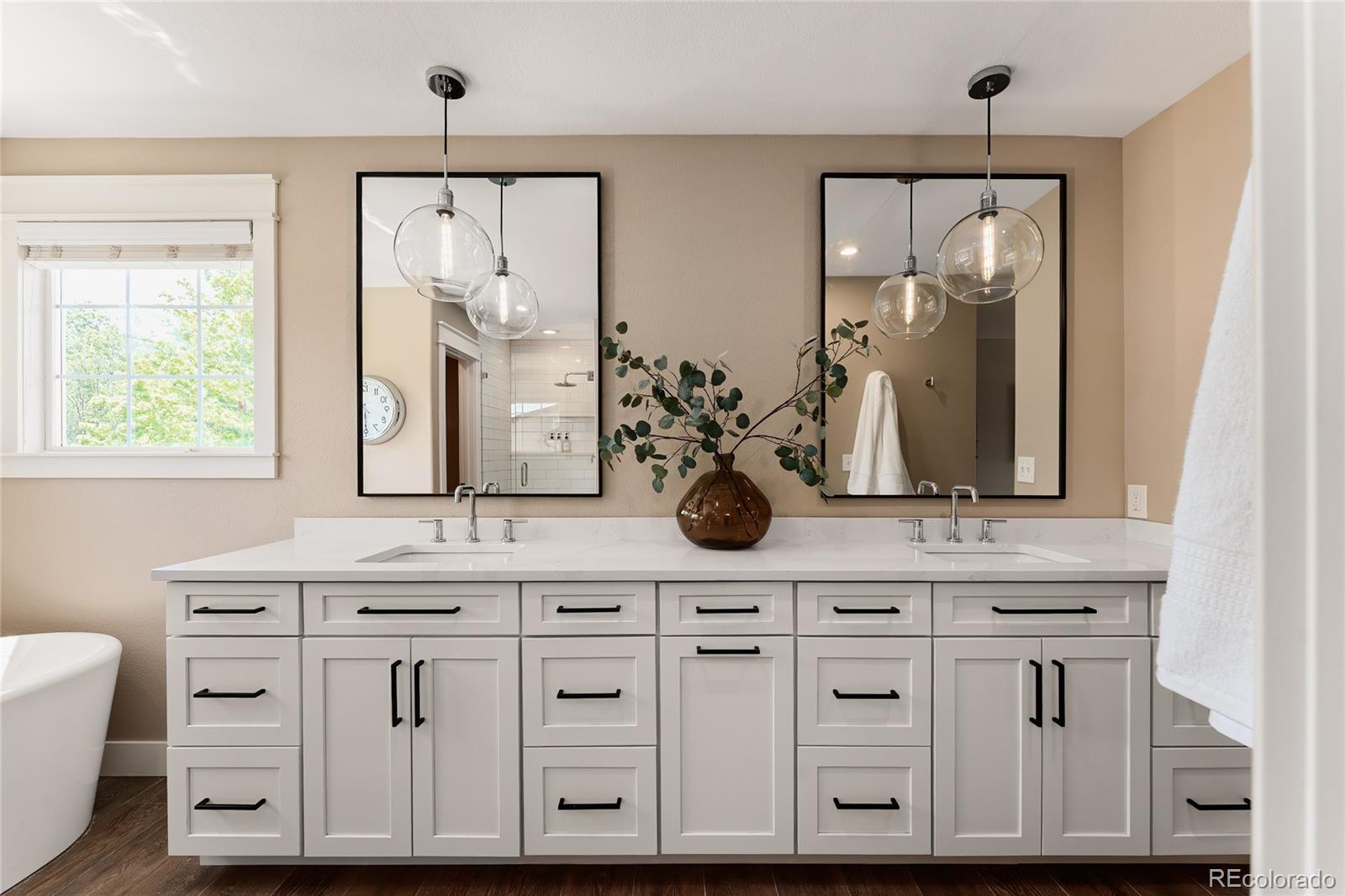 9441 South Hackberry Lane Highlands Ranch, CO 80129 - Photo 30 of 50 a bathroom with a double vanity sink mirror and