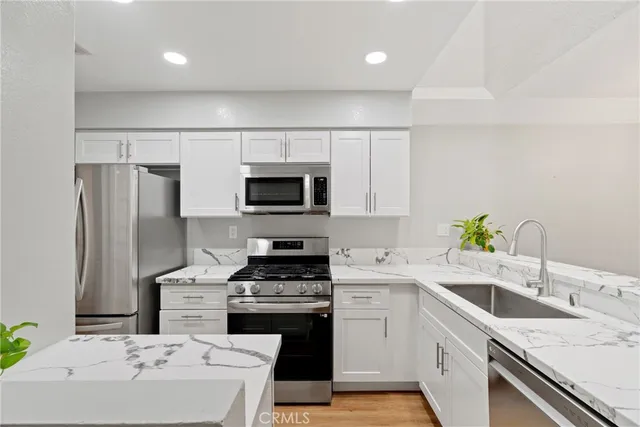 a kitchen with a sink stove and refrigerator
