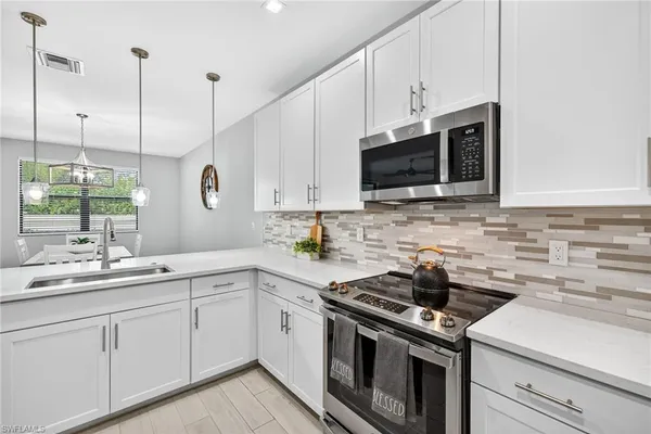 a kitchen with a sink stove and microwave