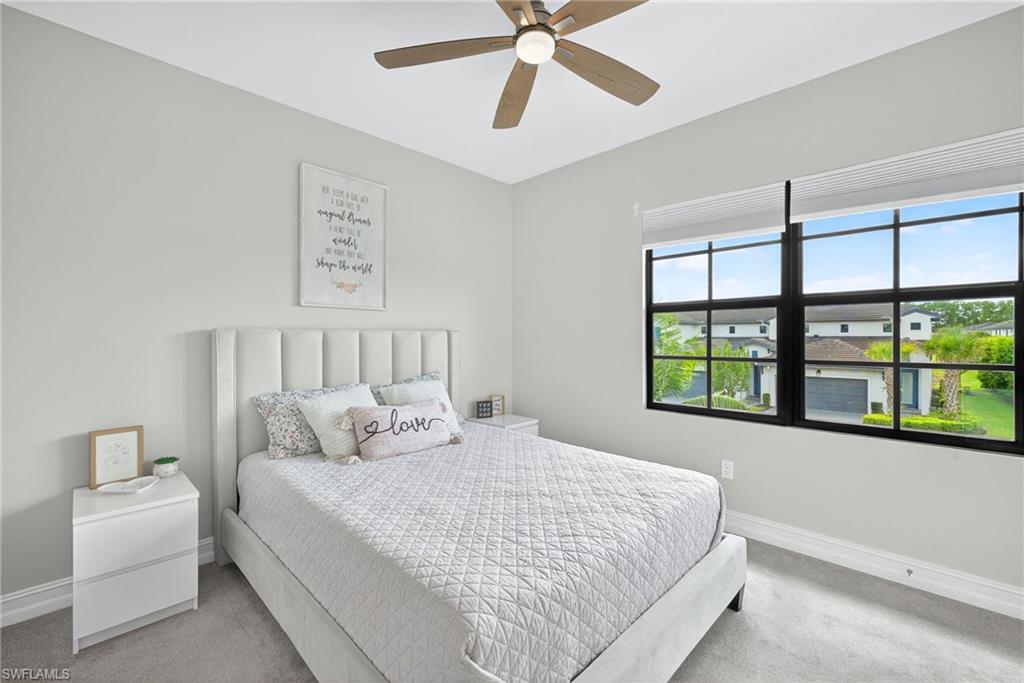7570 Rockefeller Drive Naples, FL 34119 - Photo 17 of 34 a bedroom with a large bed and a window