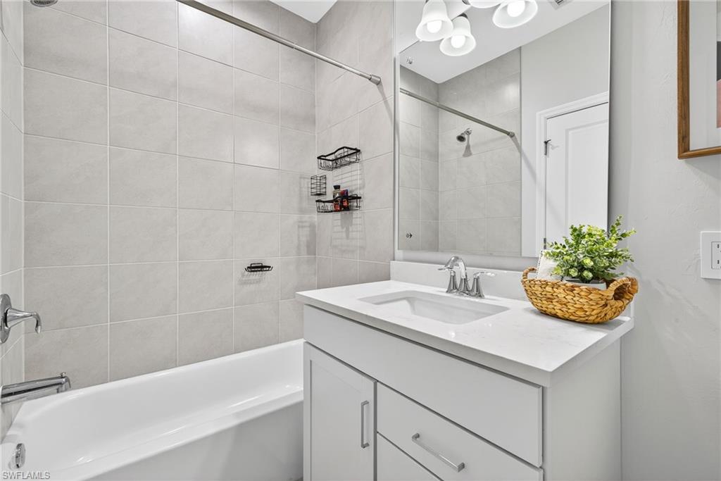 7570 Rockefeller Drive Naples, FL 34119 - Photo 19 of 34 a bathroom with a sink and a bathtub