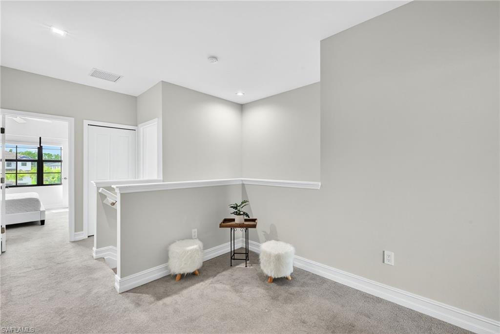 7570 Rockefeller Drive Naples, FL 34119 - Photo 26 of 34 a living room with furniture and white walls