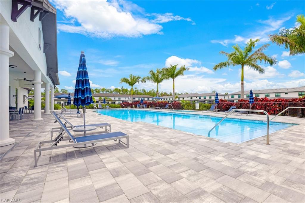 7570 Rockefeller Drive Naples, FL 34119 - Photo 30 of 34 a view of a swimming pool with a lounge chairs