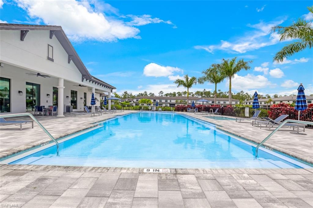 7570 Rockefeller Drive Naples, FL 34119 - Photo 32 of 34 a view of a swimming pool with an outdoor seating