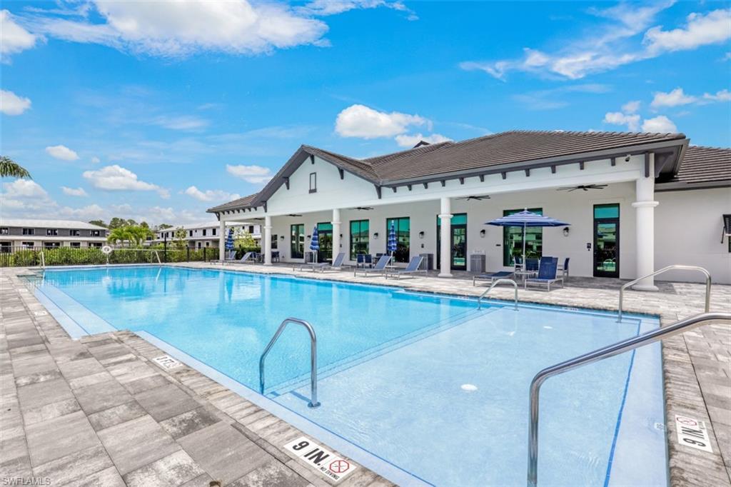 7570 Rockefeller Drive Naples, FL 34119 - Photo 33 of 34 a view of a swimming pool and lounge chair