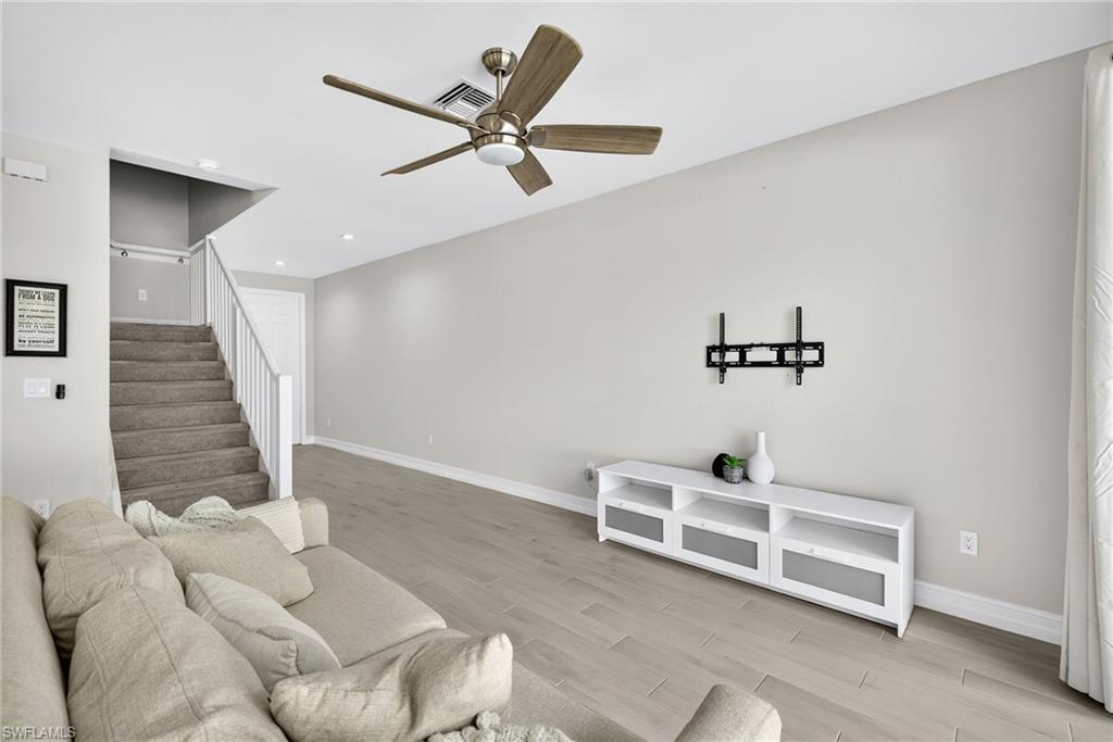 7570 Rockefeller Drive Naples, FL 34119 - Photo 5 of 34 a living room with furniture and a ceiling fan