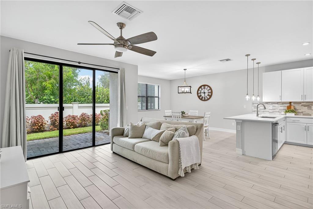 7570 Rockefeller Drive Naples, FL 34119 - Photo 6 of 34 a living room with furniture and a large window