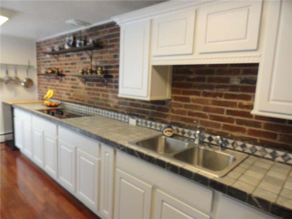 734 Field Club Road Pittsburgh, PA 15238 - Photo 11 of 25 EFFICIENTLY DESIGNED AND ARTITICALLY ENHANCED WITH EXPOSED BRICK AND TILE ACCENTS...THE UPDATED KITCHEN.