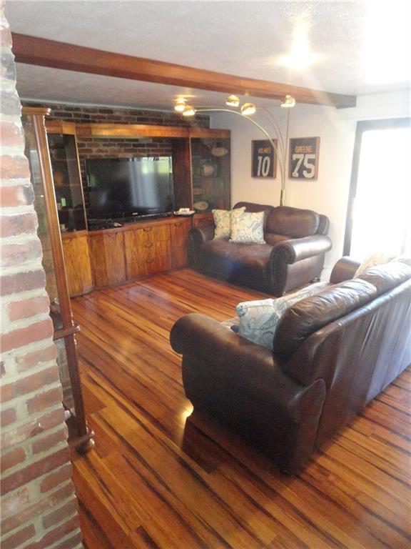 734 Field Club Road Pittsburgh, PA 15238 - Photo 6 of 25 BAMBOO FLOORS AND EXPOSED BRICK ENHANCE THE SUN FILLED LIVINGROOM.