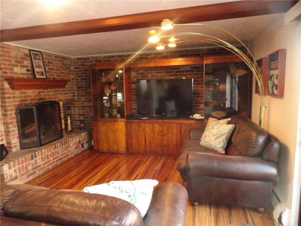 734 Field Club Road Pittsburgh, PA 15238 - Photo 7 of 25 FIREPLACE IS THE FOCAL POINT OF THE RUSTIC LIVINGROOM.