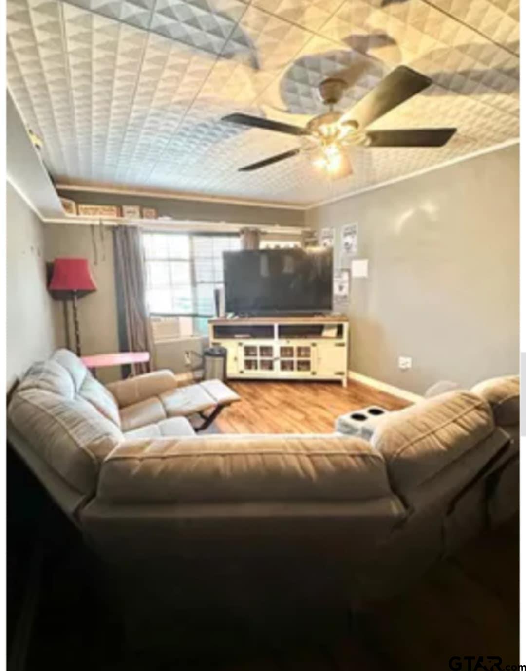 a living room with furniture and a flat screen tv