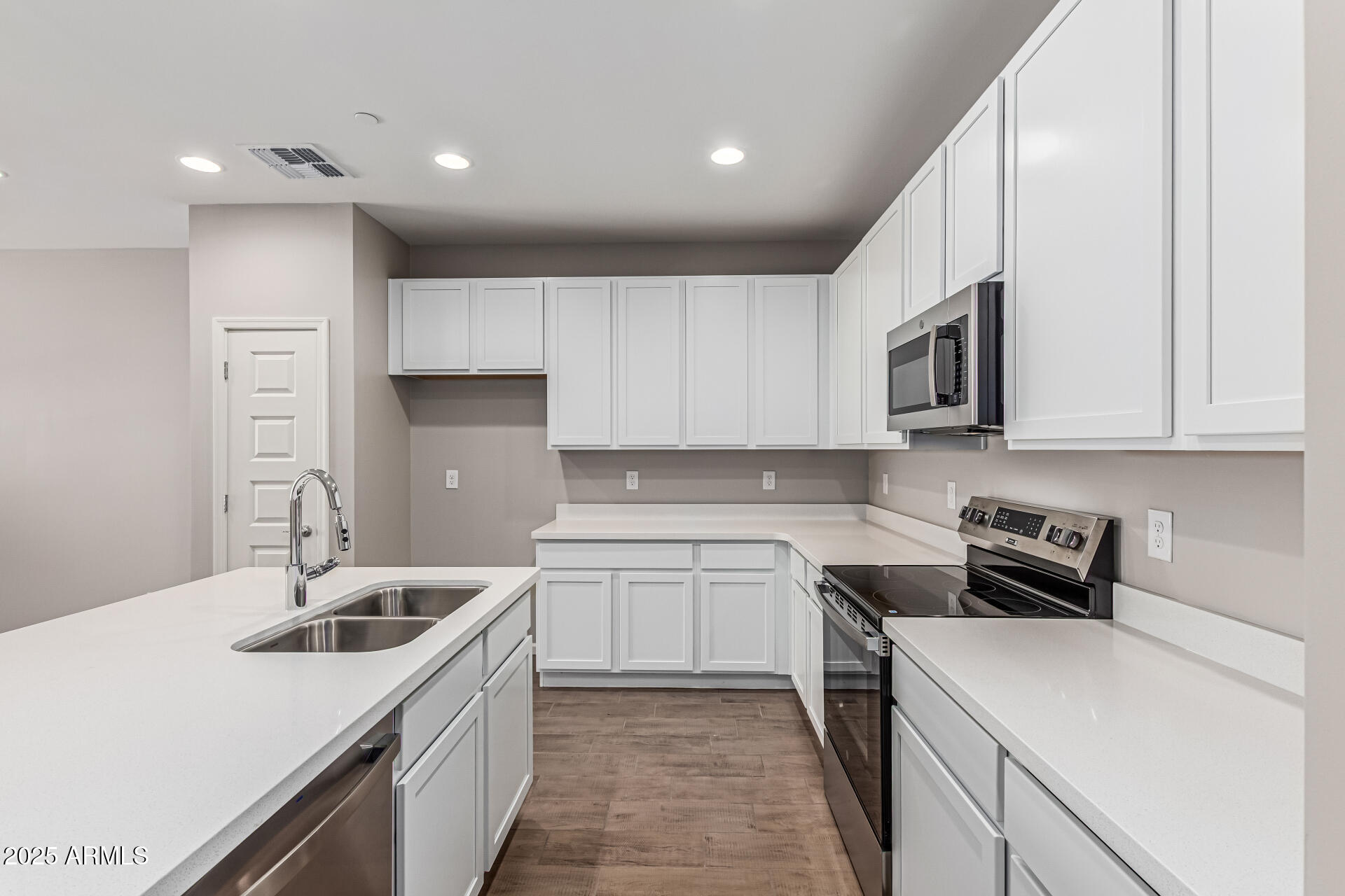 733 East Commonwealth Avenue, Unit 36 Chandler, AZ 85225 - Photo 11 of 30 a kitchen with a sink stove top oven and cabinets