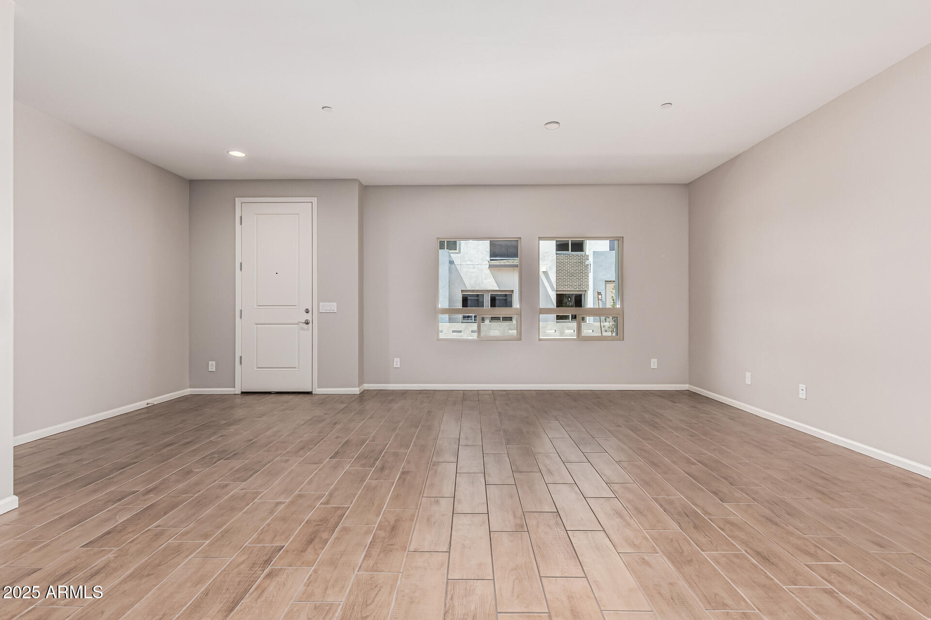 733 East Commonwealth Avenue, Unit 36 Chandler, AZ 85225 - Photo 7 of 30 a view of an empty room with a window and wooden floor