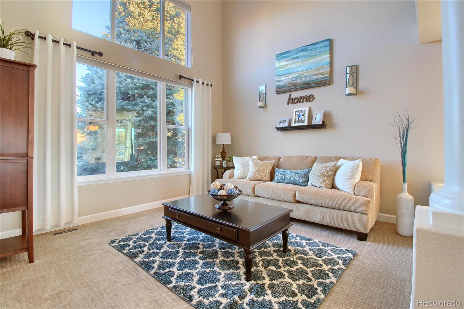 8952 Tuscany Lane Highlands Ranch, CO 80130 - Photo 1 of 32 a living room with furniture and a rug