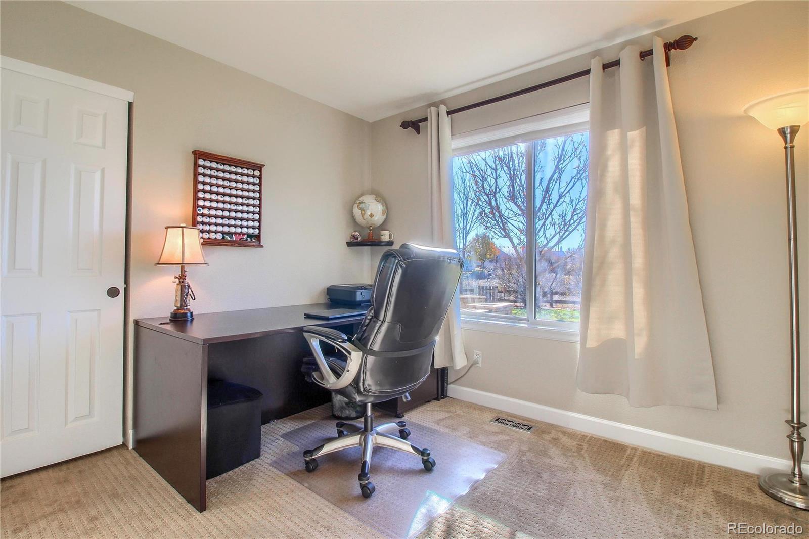 8952 Tuscany Lane Highlands Ranch, CO 80130 - Photo 12 of 32 a view of a workspace with furniture and a window