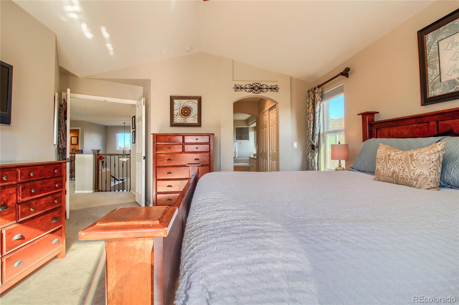 8952 Tuscany Lane Highlands Ranch, CO 80130 - Photo 15 of 32 a bedroom with furniture and a dresser