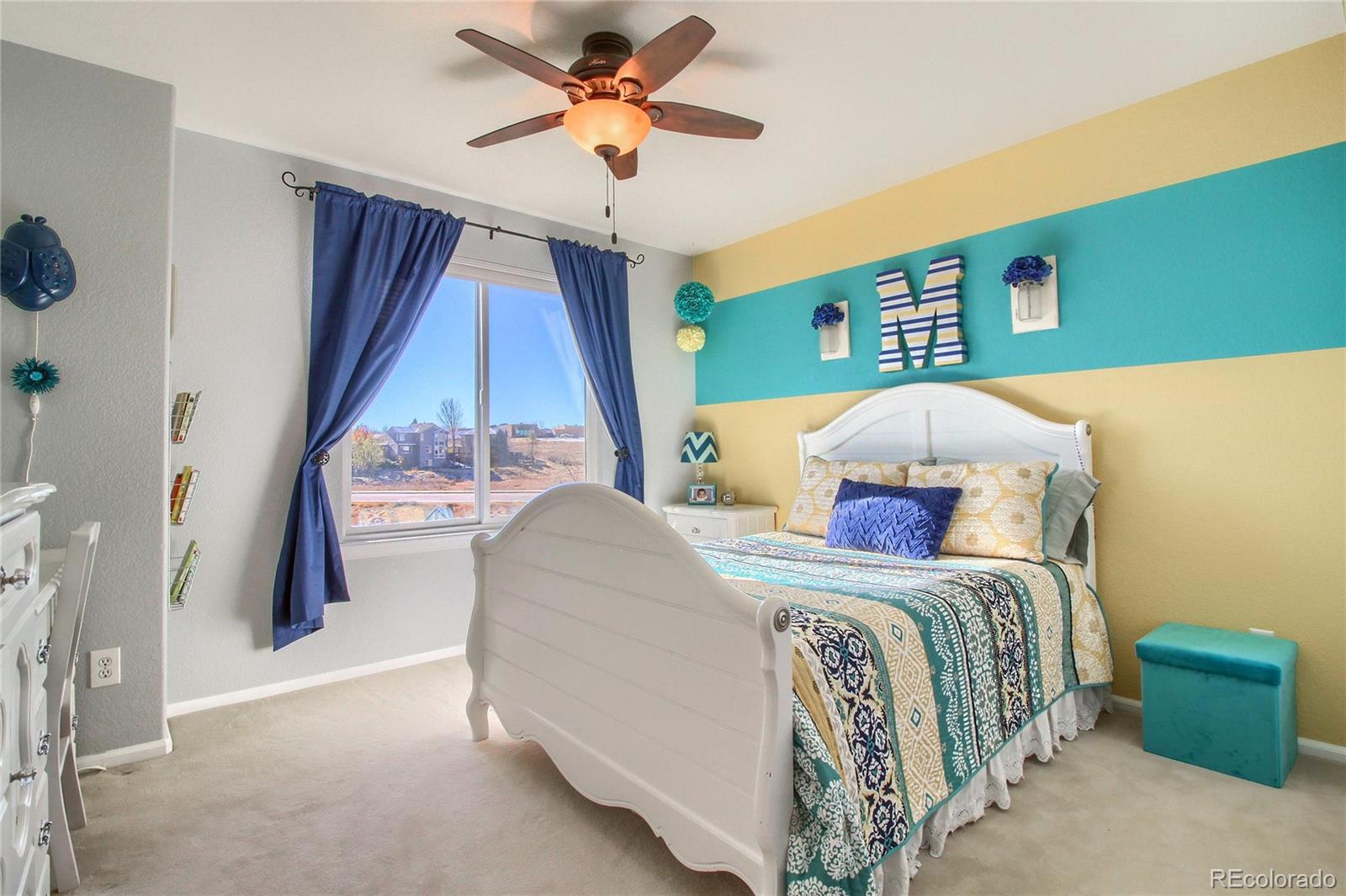 8952 Tuscany Lane Highlands Ranch, CO 80130 - Photo 19 of 32 a bed sitting in a bedroom next to a window