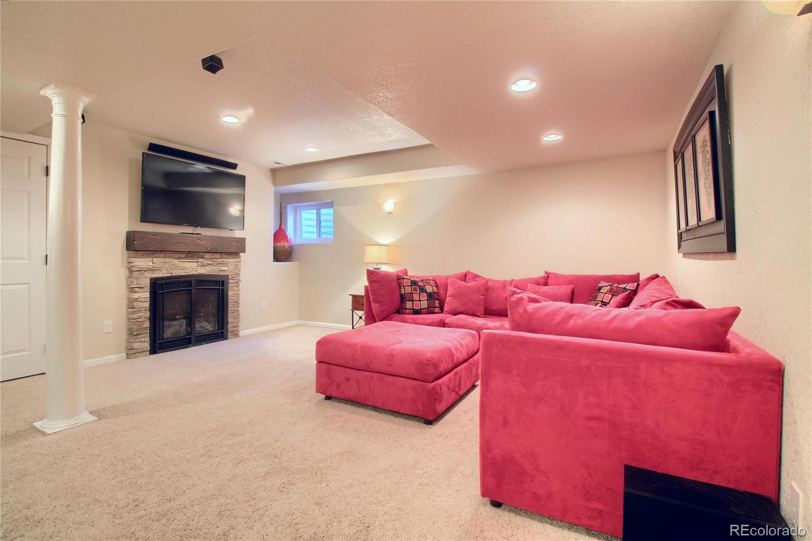 8952 Tuscany Lane Highlands Ranch, CO 80130 - Photo 23 of 32 a living room with furniture and a fireplace