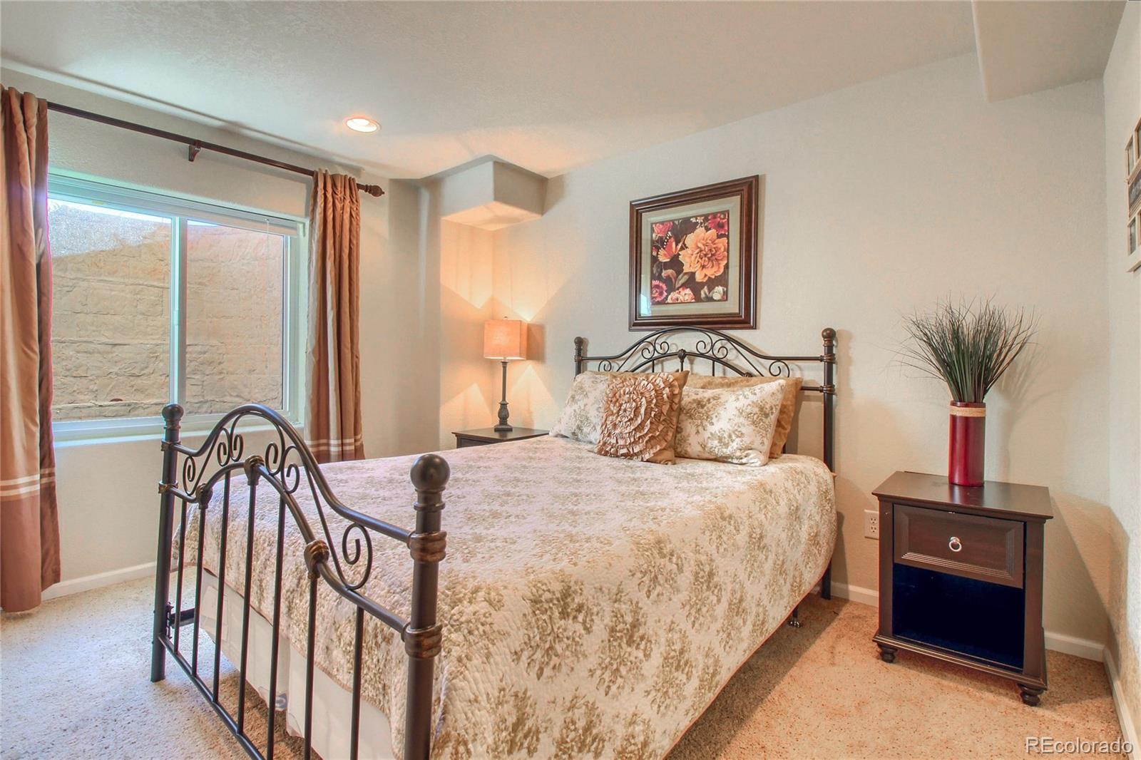 8952 Tuscany Lane Highlands Ranch, CO 80130 - Photo 24 of 32 a bedroom with a bed and a large window