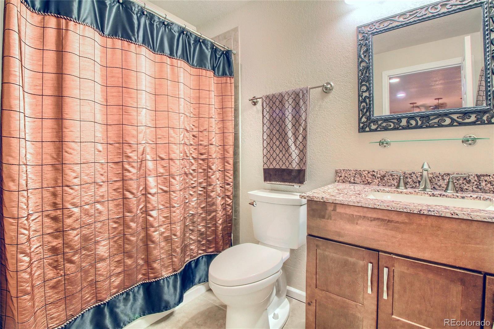 8952 Tuscany Lane Highlands Ranch, CO 80130 - Photo 26 of 32 a bathroom with a sink toilet and shower