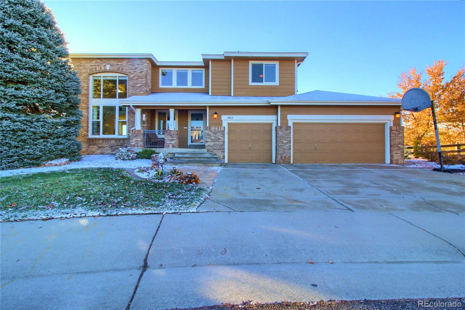 8952 Tuscany Lane Highlands Ranch, CO 80130 - Photo 27 of 32 a front view of a house with garden