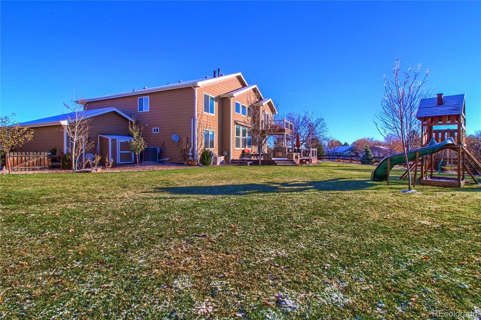 8952 Tuscany Lane Highlands Ranch, CO 80130 - Photo 28 of 32 a view of a house with a yard
