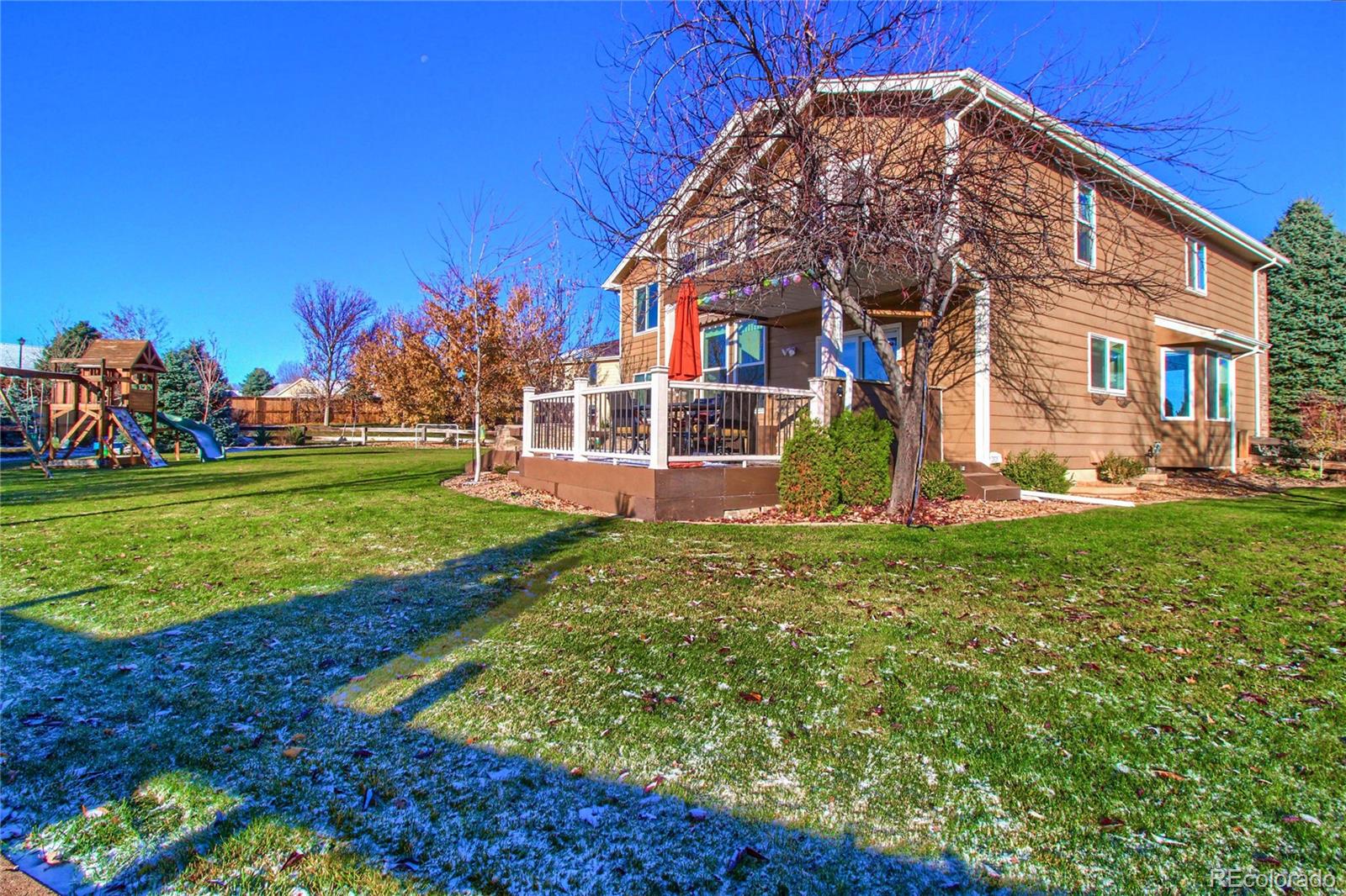 8952 Tuscany Lane Highlands Ranch, CO 80130 - Photo 29 of 32 a view of a house with a yard