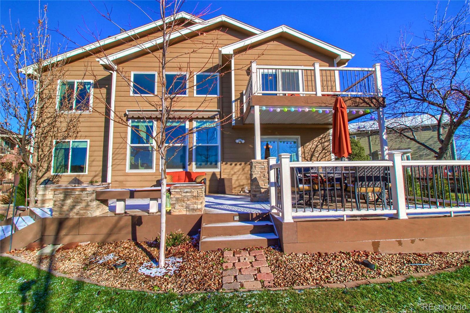 8952 Tuscany Lane Highlands Ranch, CO 80130 - Photo 30 of 32 a front view of a house with garden