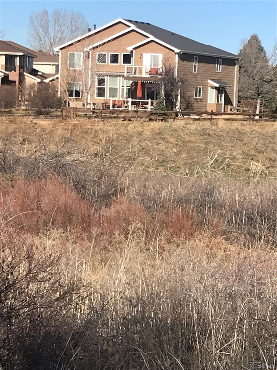 8952 Tuscany Lane Highlands Ranch, CO 80130 - Photo 32 of 32 a front view of a house with a yard