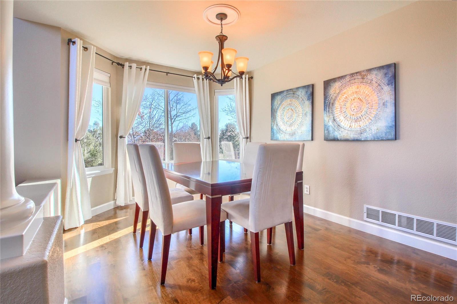 8952 Tuscany Lane Highlands Ranch, CO 80130 - Photo 5 of 32 a view of a dining room with furniture window and wooden floor