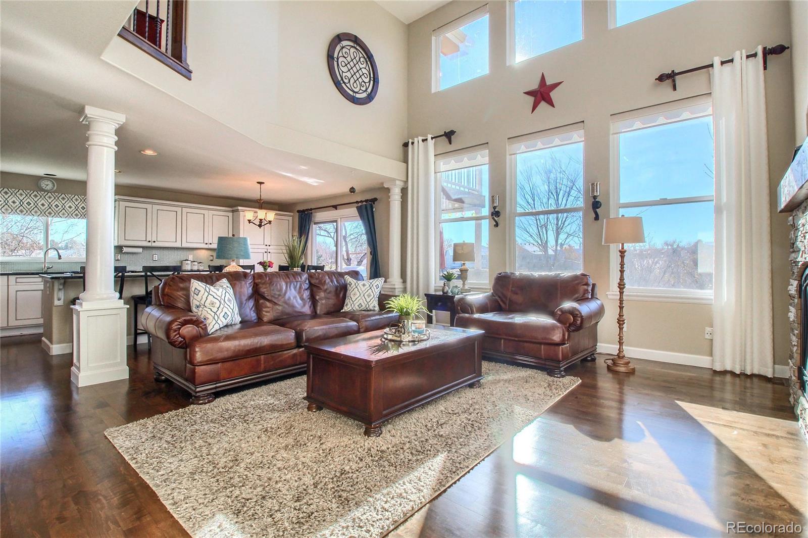 8952 Tuscany Lane Highlands Ranch, CO 80130 - Photo 7 of 32 a living room with furniture wooden floor and a large window